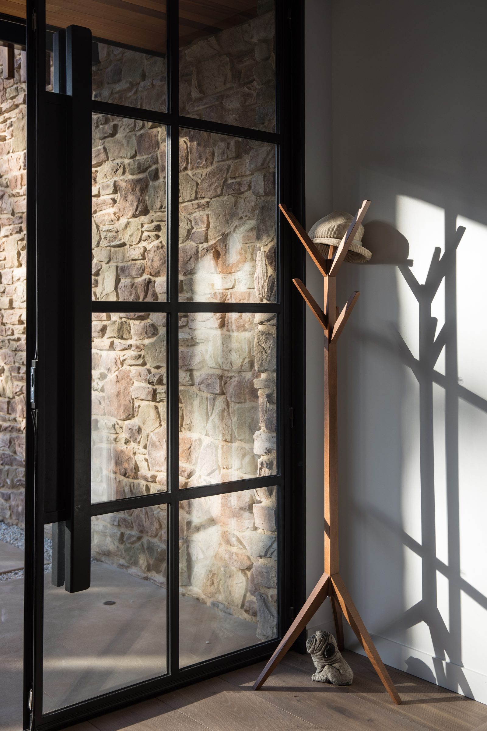 Threshold detail — steel framing meets schist